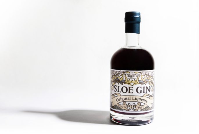 A bottle of The Wiltshire Liqueur Company's Sloe Gin on a white background.