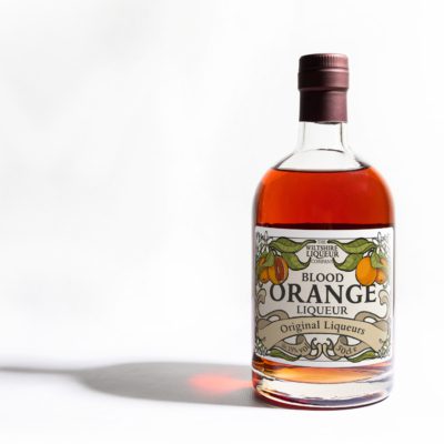 A bottle of Blood Orange Liqueur from the Wiltshire Liqueur Company, on a white background.